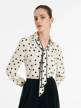 a lady in a silk polka dots printed shirt with flaps